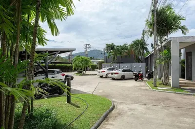 a group of cars parked in a parking lot at VILLA ARU Private Pool 3 min to Naiharn Beach in Nai Harn Beach