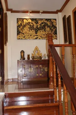 a room with a wooden staircase with a dresser at Prince Edouard Apartments & Resort Patong Beach Phuket in Patong Beach