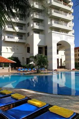 a swimming pool in front of a building at Waterfront Suites Phuket by Centara in Karon Beach