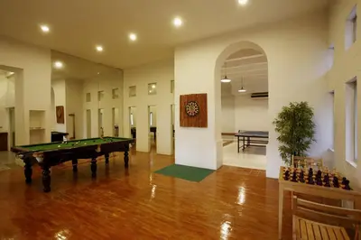 a large room with a pool table and a room with at Waterfront Suites Phuket by Centara in Karon Beach