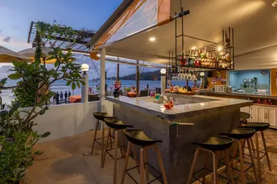 a bar with a view of the ocean at Kamala Dreams in Kamala Beach