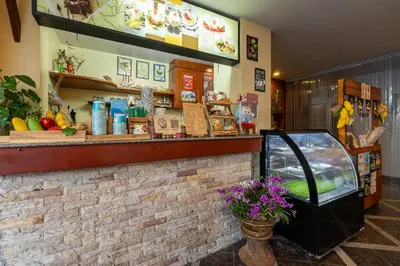 a shop with a counter and a flower pot at Kamala Dreams in Kamala Beach