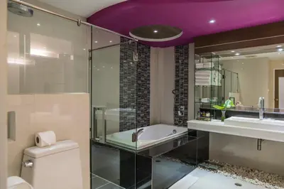 a bathroom with a tub and a sink and a toilet at The L Resort, Krabi in Ao Nang Beach