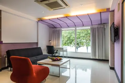 a living room with a couch and a table at The L Resort, Krabi in Ao Nang Beach