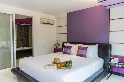 a bedroom with a bed with a basket of fruit on it at The L Resort, Krabi in Ao Nang Beach