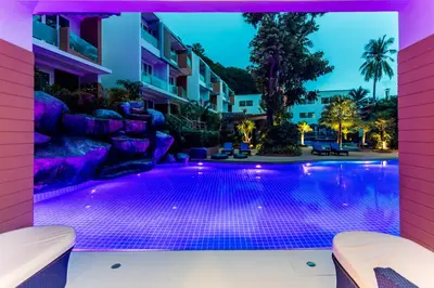 a swimming pool with purple lights in a building at The L Resort, Krabi in Ao Nang Beach