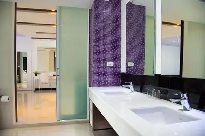 a bathroom with two sinks and a large mirror at The L Resort, Krabi in Ao Nang Beach