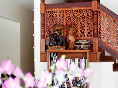 a book shelf with vases and books on it at The Orchid House - SHA Extra Plus in Kata Beach