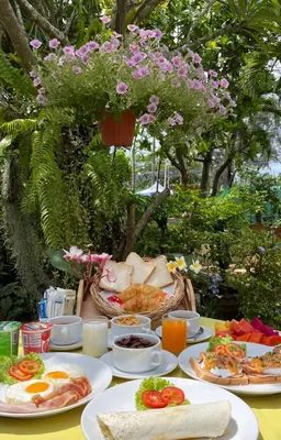 a table with plates of food on top of it at Phuket Golden Sand Inn - SHA Extra Plus in Karon Beach