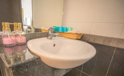 a bathroom counter with a sink and a mirror at Sino House Patong in Patong Beach