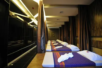 a row of beds lined up in a room at C & N Resort and Spa - SHA Extra Plus in Patong Beach