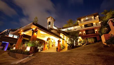 a building with stairs in front of a building at night at C & N Resort and Spa - SHA Extra Plus in Patong Beach