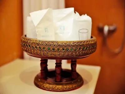 a basket of toilet paper sitting on a table at Baan SS Karon in Karon Beach