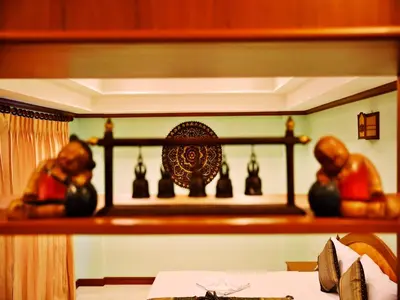 a room with a shelf with figurines on it at Baan SS Karon in Karon Beach