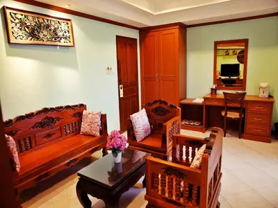 a living room with wooden furniture and a desk at Baan SS Karon in Karon Beach