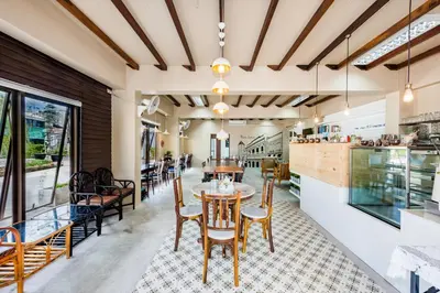 a dining room with a table and chairs at Pure Phuket Residence in Phuket Town