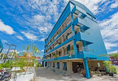 a blue building with a sky in the background at Pure Phuket Residence in Phuket Town