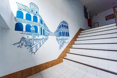 a staircase with blue and white mural on the wall at Pure Phuket Residence in Phuket Town