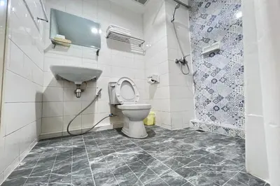 a bathroom with a toilet and a shower at Pure Phuket Residence in Phuket Town