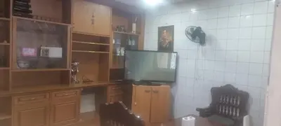 a living room with a tv and a desk with a television at Blue Paradise Residence in Rawai Beach