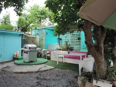 a backyard with a table and chairs and a tree at Blue Paradise Residence in Rawai Beach