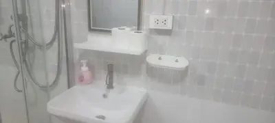 a white bathroom with a shower and a sink at Blue Paradise Residence in Rawai Beach