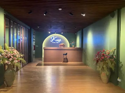 a view of a salon with a counter and flowers at Keep Aonang in Ao Nang Beach