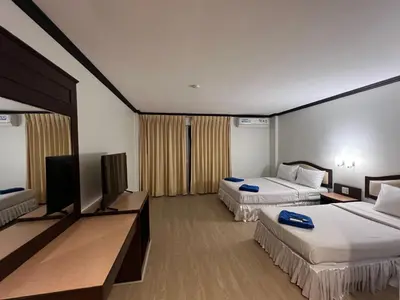 a hotel room with two beds and a flat screen tv at Keep Aonang in Ao Nang Beach