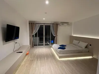 a bedroom with a bed and a flat screen tv at Keep Aonang in Ao Nang Beach