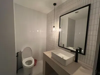 a bathroom with a toilet and a sink and a mirror at Keep Aonang in Ao Nang Beach