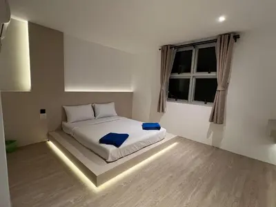a bedroom with a bed with lights on the floor at Keep Aonang in Ao Nang Beach