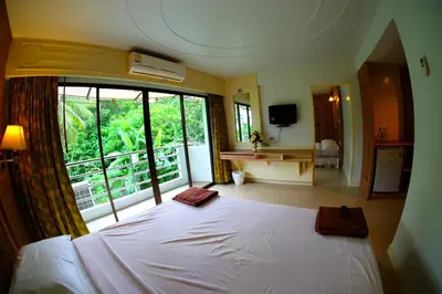 a bedroom with a white bed and a large window at Aonang Top View in Ao Nang Beach