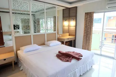 a bedroom with a large white bed with towels on it at Aonang Top View in Ao Nang Beach