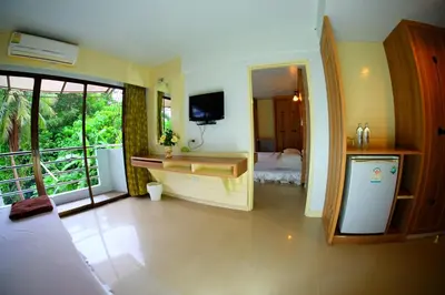 a room with a bedroom with a bed and a television at Aonang Top View in Ao Nang Beach