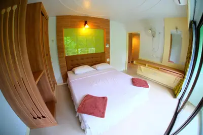 a bedroom with a white bed and a mirror at Aonang Top View in Ao Nang Beach