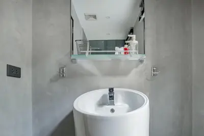 a white bathroom with a sink and a mirror at Woodpecker Villa - Kamala Beach in Kamala Beach