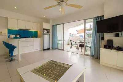 a living room with a kitchen and a dining room at Heritage Condominium - Patong Beach in Patong Beach