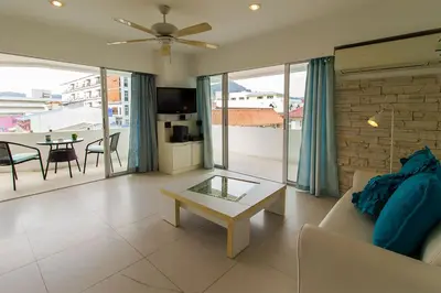 a living room with a couch and a table at Heritage Condominium - Patong Beach in Patong Beach