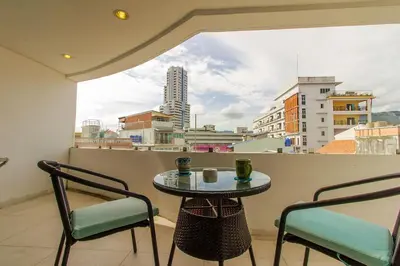 a table and chairs on a balcony with a view at Heritage Condominium - Patong Beach in Patong Beach