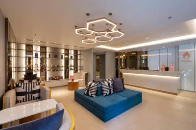 a store lobby with a blue couch and chairs at The Nature Phuket in Patong Beach