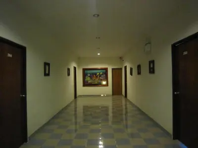 an empty hallway with a painting on the wall at P.K. Mansion in Ao Nang Beach