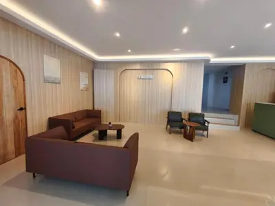 a living room with a couch and a table and chairs at P.K. Mansion in Ao Nang Beach