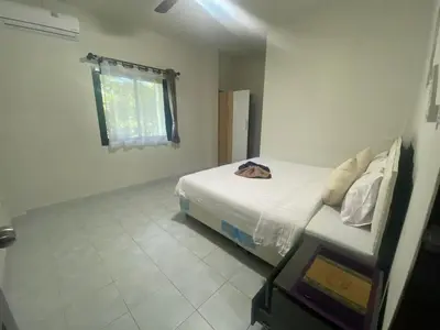 a white bedroom with a bed and a window at Sabai Resort in Ao Nang Beach