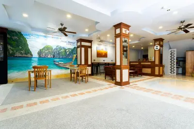 a living room with a painting on the wall at Amorn Mansion in Ao Nang Beach
