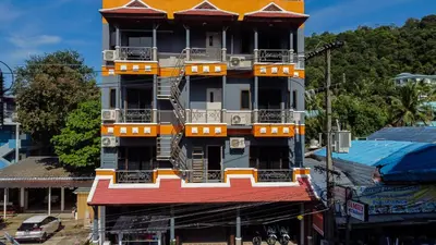 a tall building with balconies on the side of it at Amorn Mansion in Ao Nang Beach