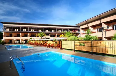 a hotel with a swimming pool in front of a building at Maleedee Bay Resort in Ao Nang Beach