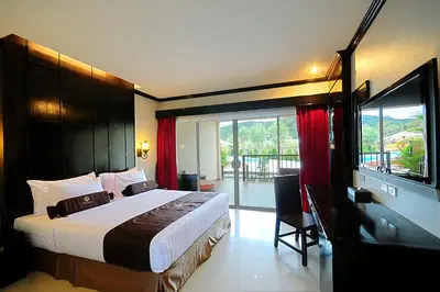 a bedroom with a large bed and a large window at Maleedee Bay Resort in Ao Nang Beach