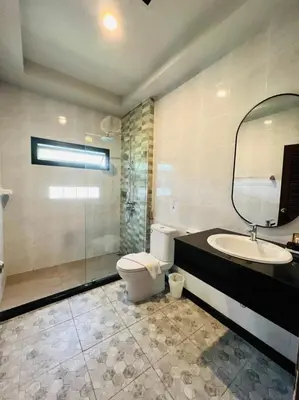 a bathroom with a sink and a toilet and a mirror at Maleedee Bay Resort in Ao Nang Beach