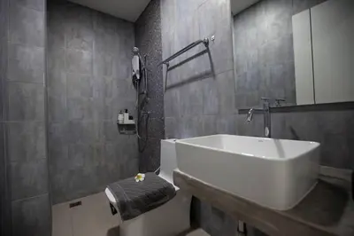 a bathroom with a white sink and a toilet at Be Live Residence in Thalang