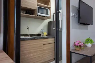 a small kitchen with a sink and a microwave at Be Live Residence in Thalang